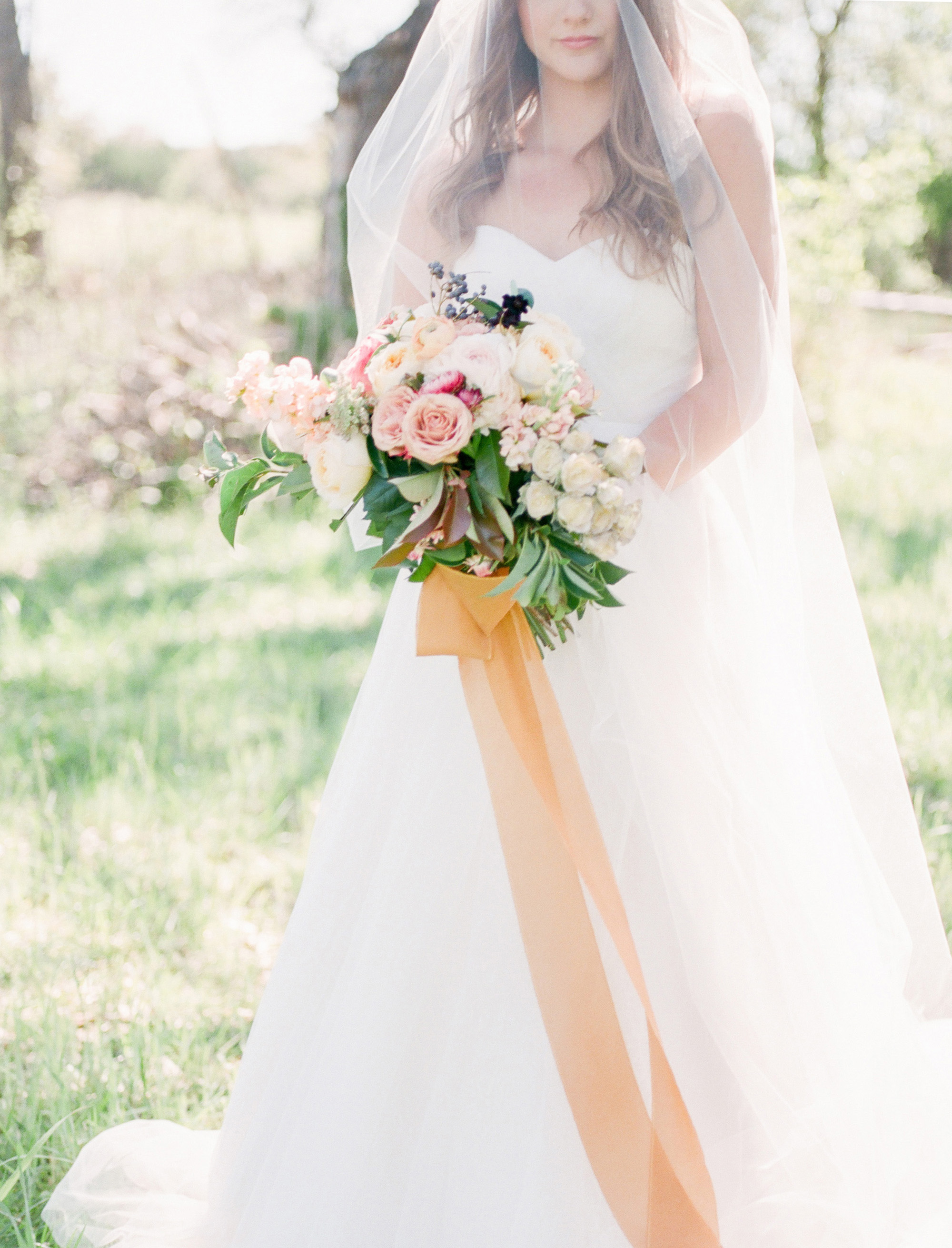 Garden bouquet with silk ribbon and Martina Liana bridal gown at a Dallas wedding.