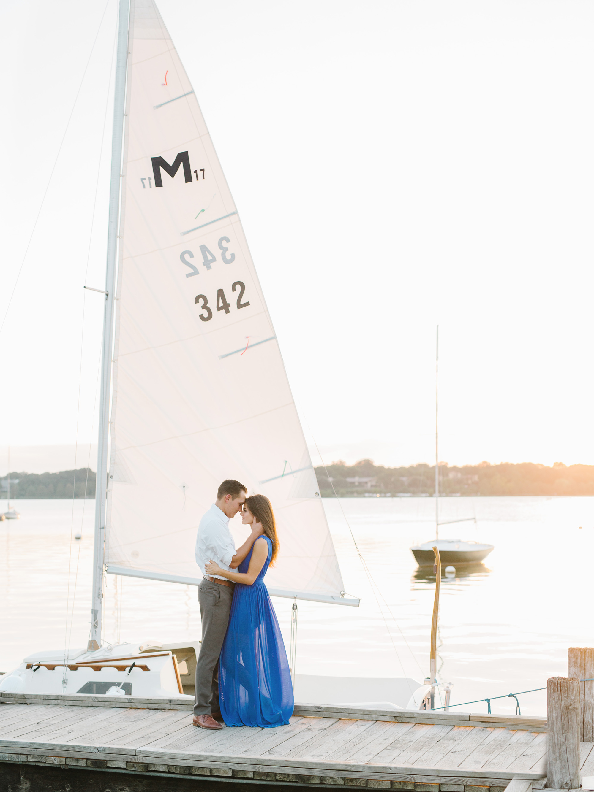 Sunset sailboat engagement photos by Texas wedding photographer Tenth & Grace.