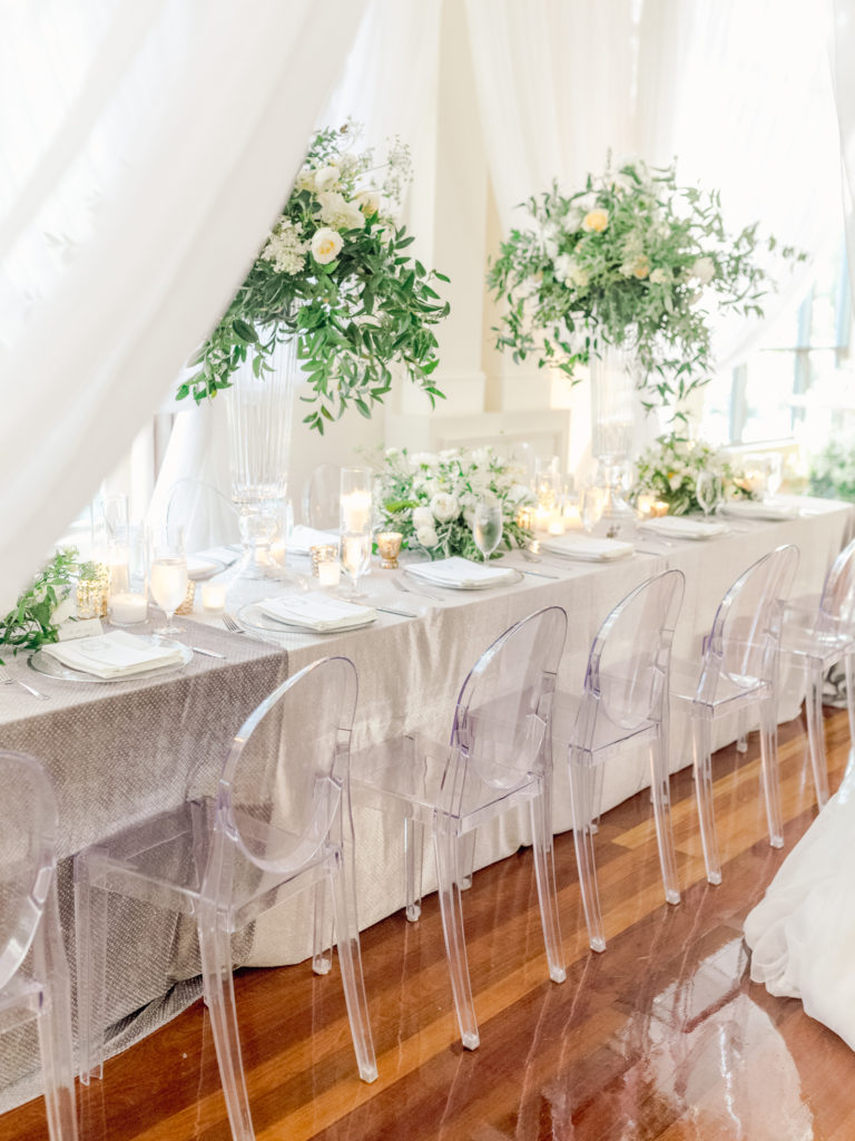 Ghost chairs and lush greenery at this Swan House wedding.